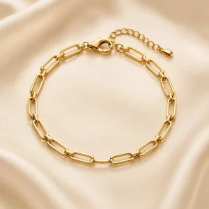Polished rectangular-link gold-tone bracelet on ivory satin