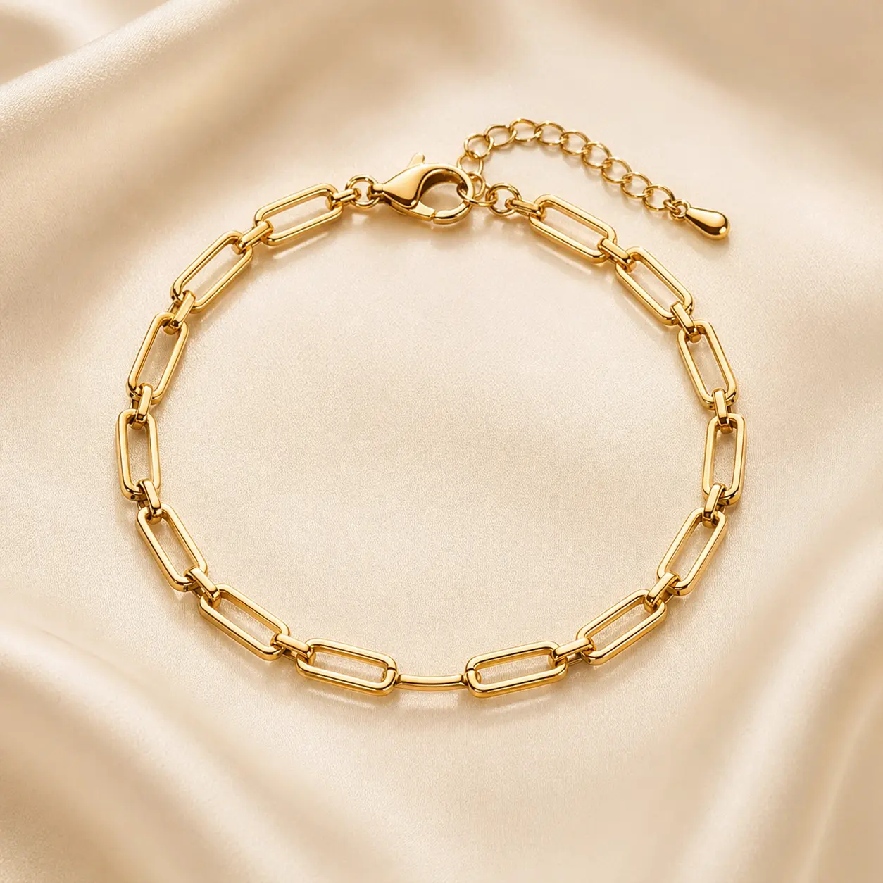 Polished rectangular-link gold-tone bracelet on ivory satin