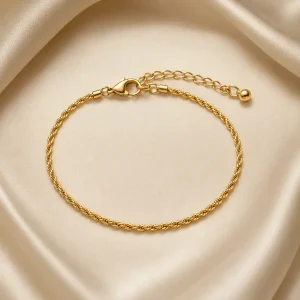 Fine gold-tone rope-chain bracelet on ivory satin